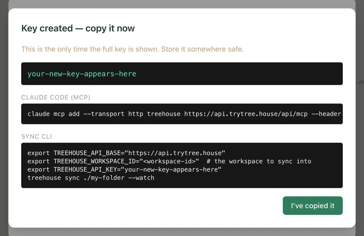 The API keys dialog showing a new key, with the ready-to-run Claude Code command below it