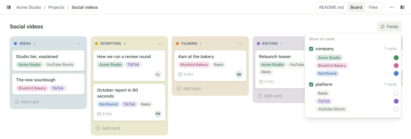 A social videos board with coloured columns, company chips coloured per company, and the Fields panel open listing company and platform with a colour beside each value
